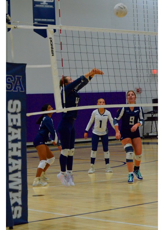 Sussex Academy sophomore Zoe Kornmann jump bumps the ball.